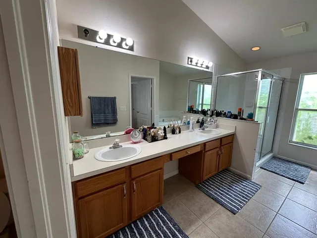 a bathroom with a double vanity sink and a mirror