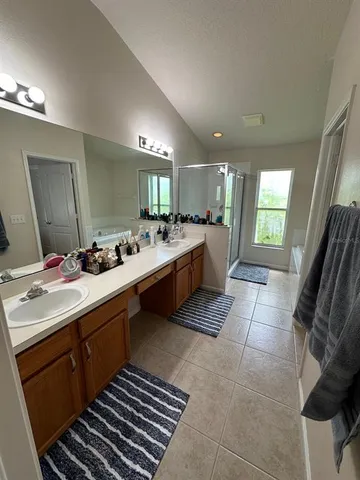 a large bathroom with a double vanity sink and a mirror