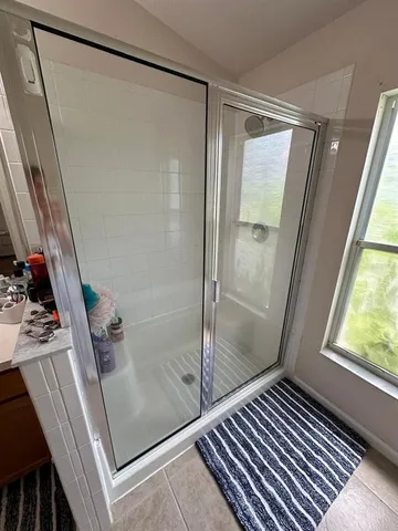 a bathroom with a glass shower door