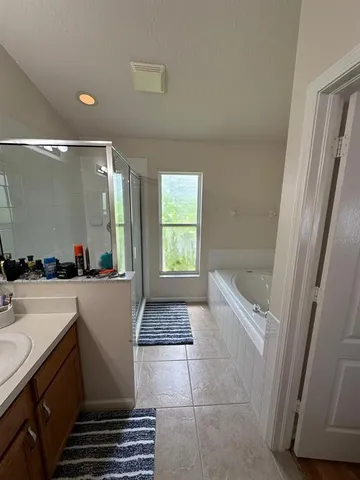 a bathroom with a bathtub and window