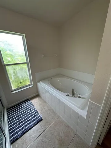 a bedroom with bed and window