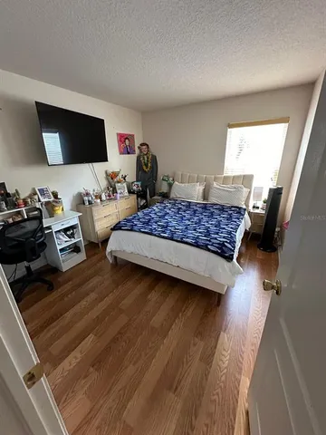 a bed sitting in a bedroom next to a window