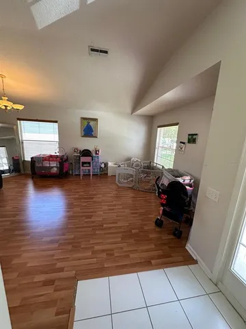 a living room with furniture and a mirror