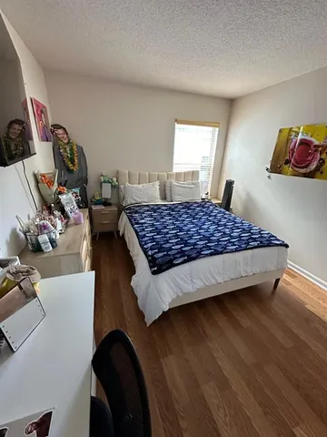 a bedroom with bed chair and a window