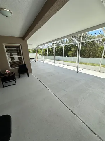 a view of a livingroom with furniture and floor to ceiling window