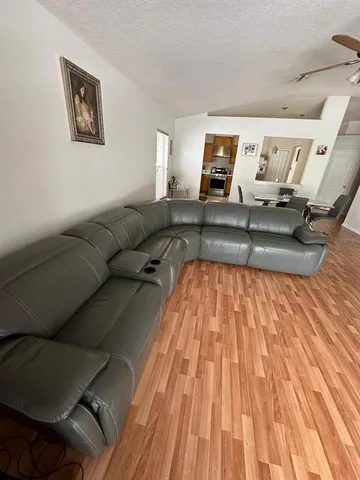 a living room with a couch and wooden floor