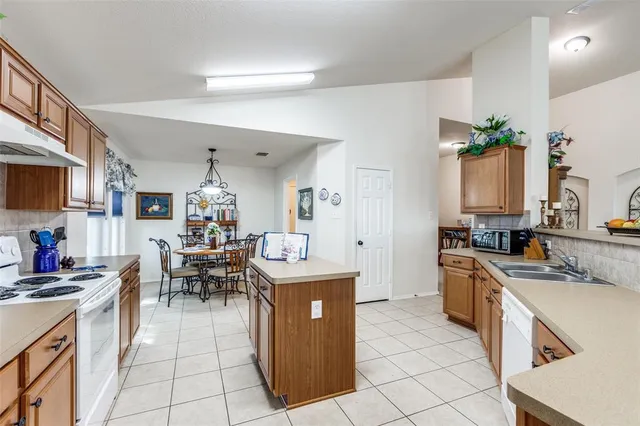 a kitchen with kitchen island granite countertop a sink and counter space