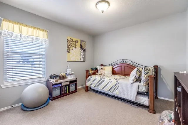 a bedroom with bed and a window