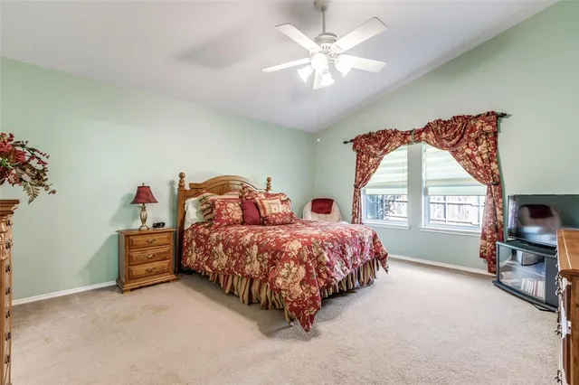 a spacious bedroom with two beds and a chandelier