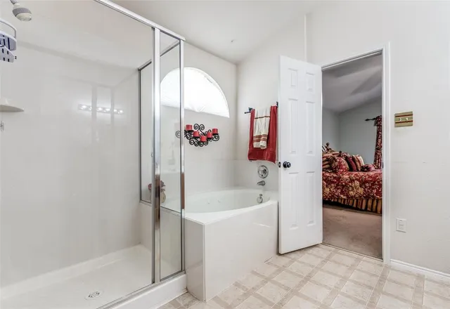 a bathroom with a tub and shower