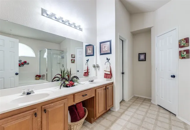 a bathroom with a sink double vanity and a mirror