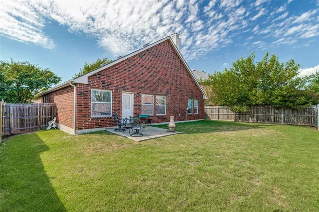 a view of a house with pool and sitting area