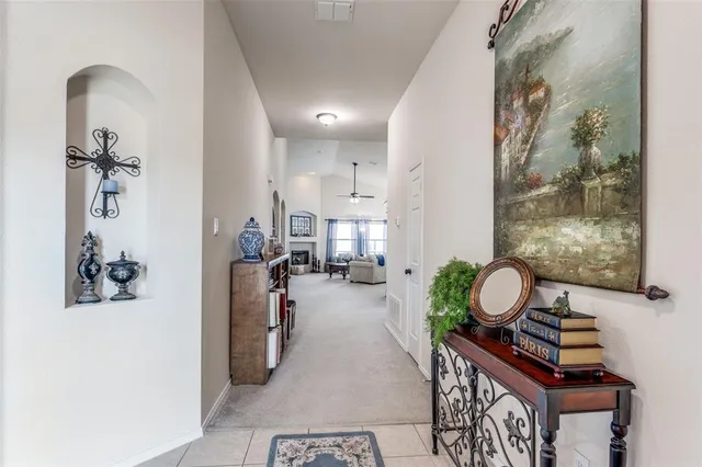 a view of a hallway with dining room and wooden floor