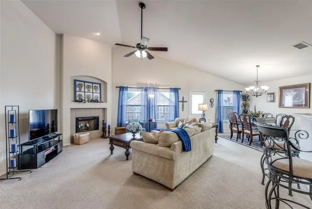 a living room with fireplace furniture and a flat screen tv