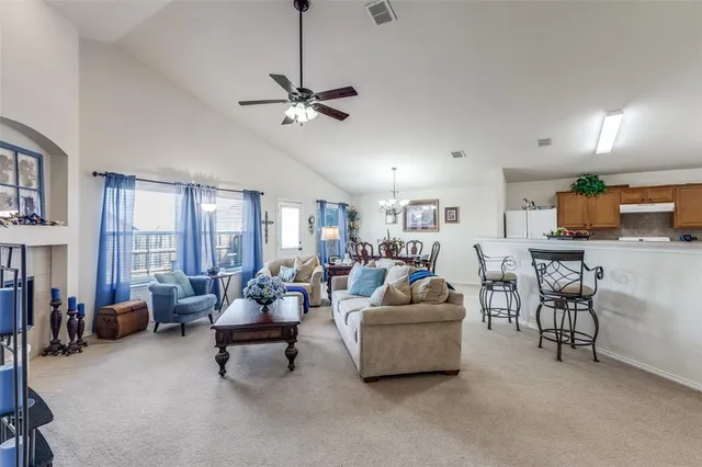 a living room with furniture and a chandelier