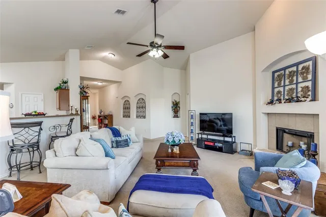 a living room with furniture fireplace and flat screen tv