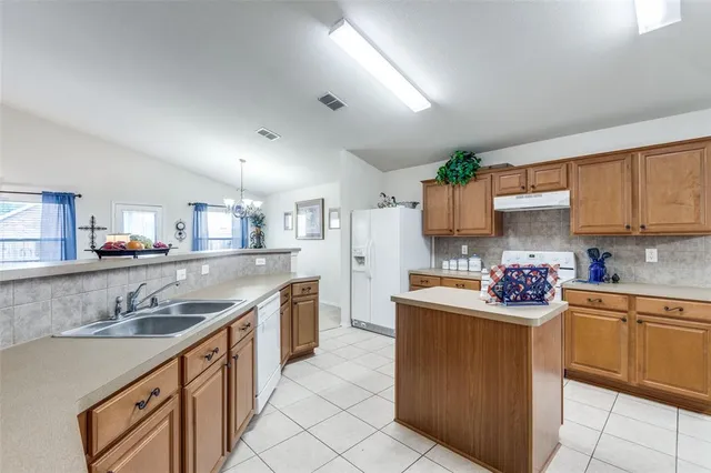 a kitchen with a sink stove top oven and cabinets