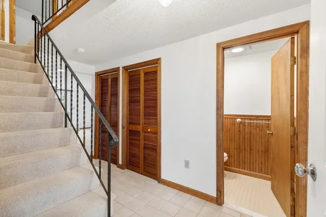 a view of staircase with wooden floor and a chair
