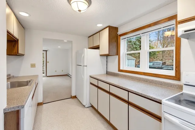 a kitchen with stainless steel appliances granite countertop a refrigerator and a sink