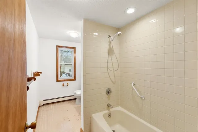 a bathroom with a shower a bathtub and a shower