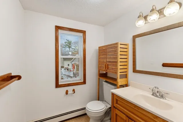 a bathroom with a sink a mirror and a toilet