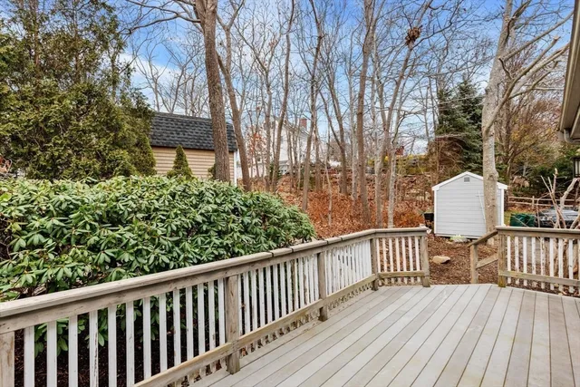 a view of roof deck with wooden floor and fence