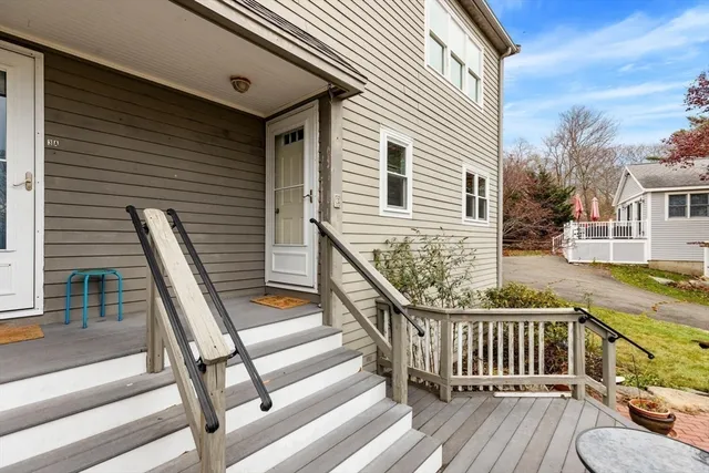 a view of a balcony with two chairs and wooden fence