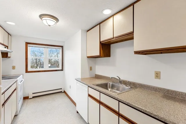 a kitchen with stainless steel appliances granite countertop a sink a stove and a microwave