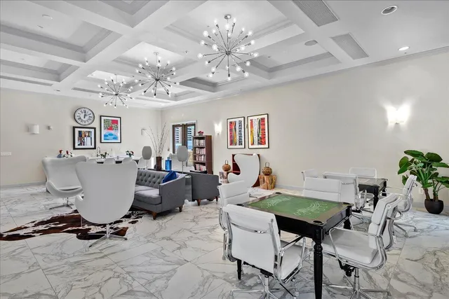 a view of a dining room with furniture and a chandelier fan