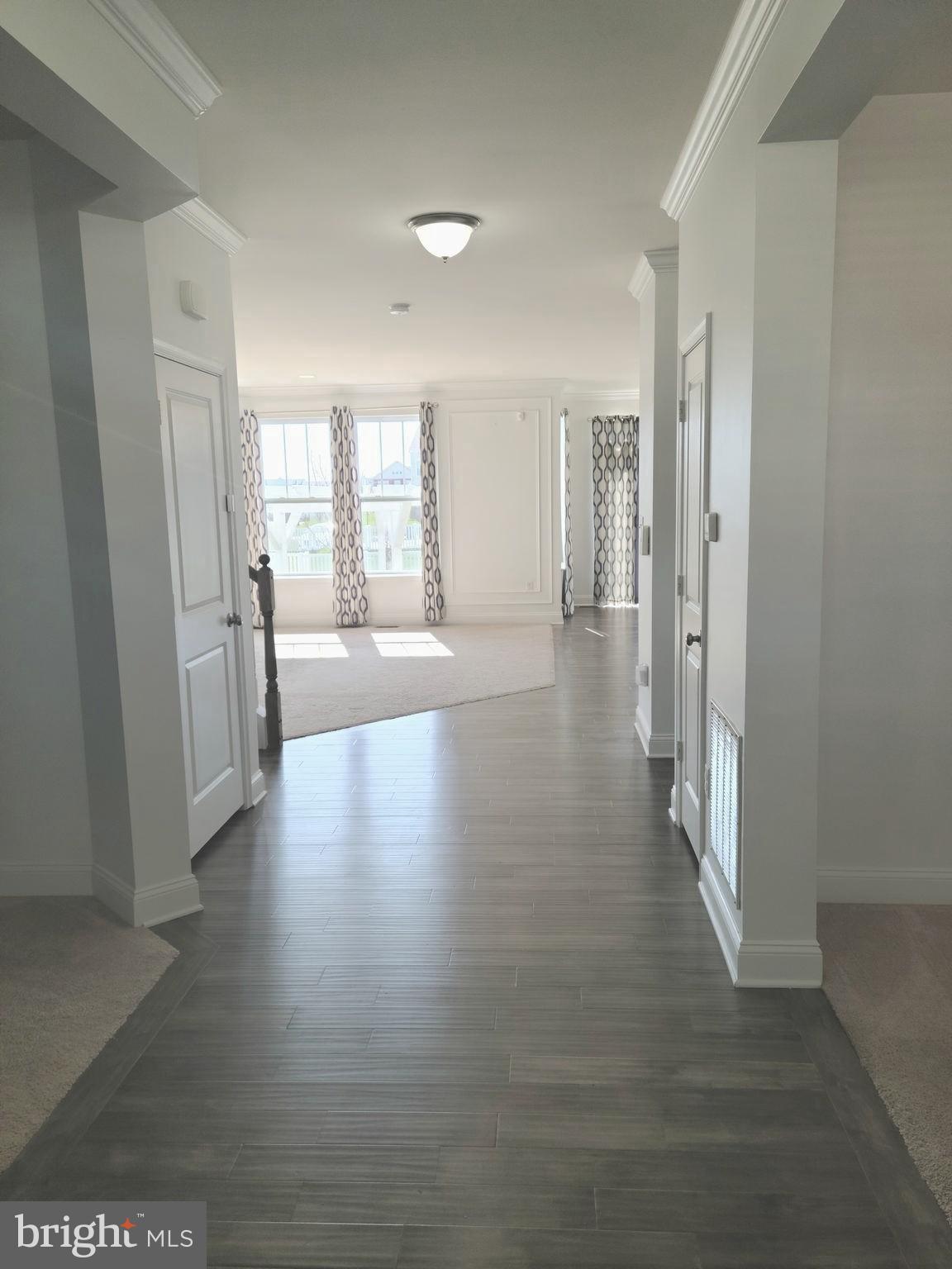 1756 Michelangelo Drive Middletown, DE 19709 - Photo 2 of 24 a view of an empty room with wooden floor and a window