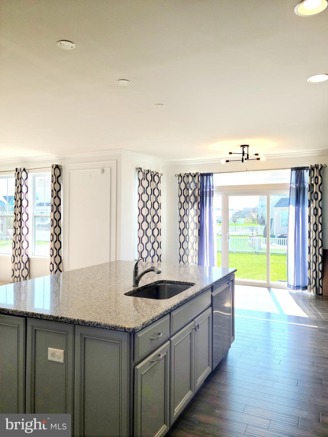 1756 Michelangelo Drive Middletown, DE 19709 - Photo 4 of 24 a kitchen with stainless steel appliances granite countertop a sink and a large window