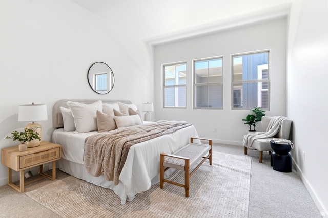 7243 West Terraine Road West Jordan, UT 84081 - Photo 13 of 31 Bedroom featuring high ceilings, three large windows, light-colored carpeting, and a round wall-mounted mirror
