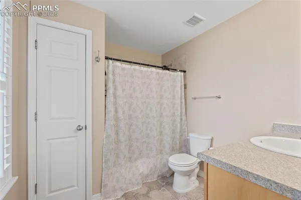 a bathroom with a sink vanity and a mirror