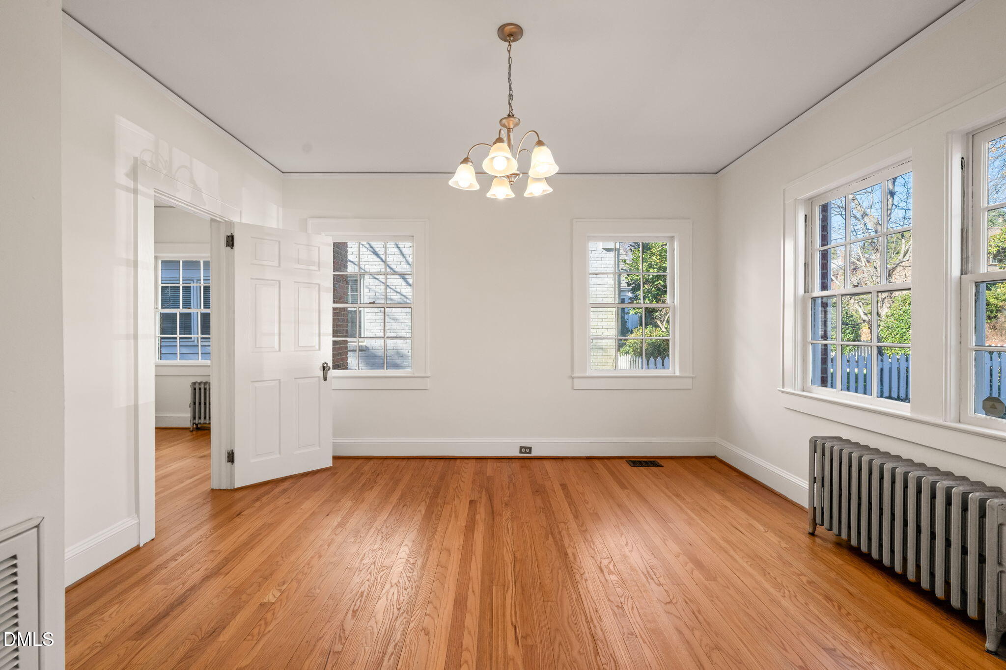 907 West Johnson Street Raleigh, NC 27605 - Photo 12 of 43 a view of an empty room with wooden floor and a window