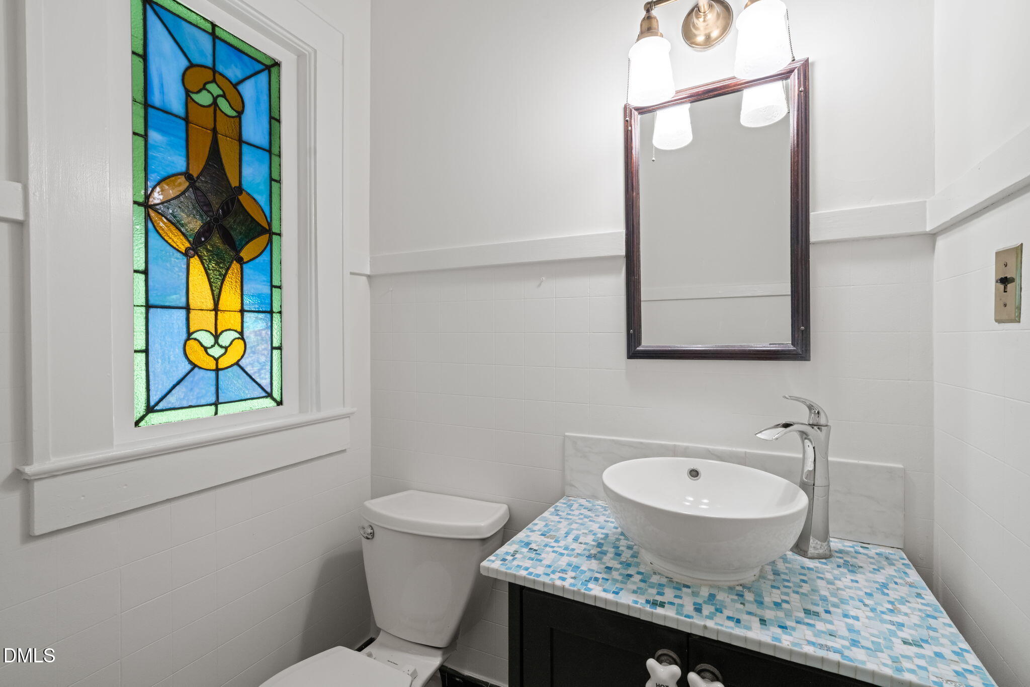 907 West Johnson Street Raleigh, NC 27605 - Photo 17 of 43 a bathroom with a granite countertop toilet sink and mirror