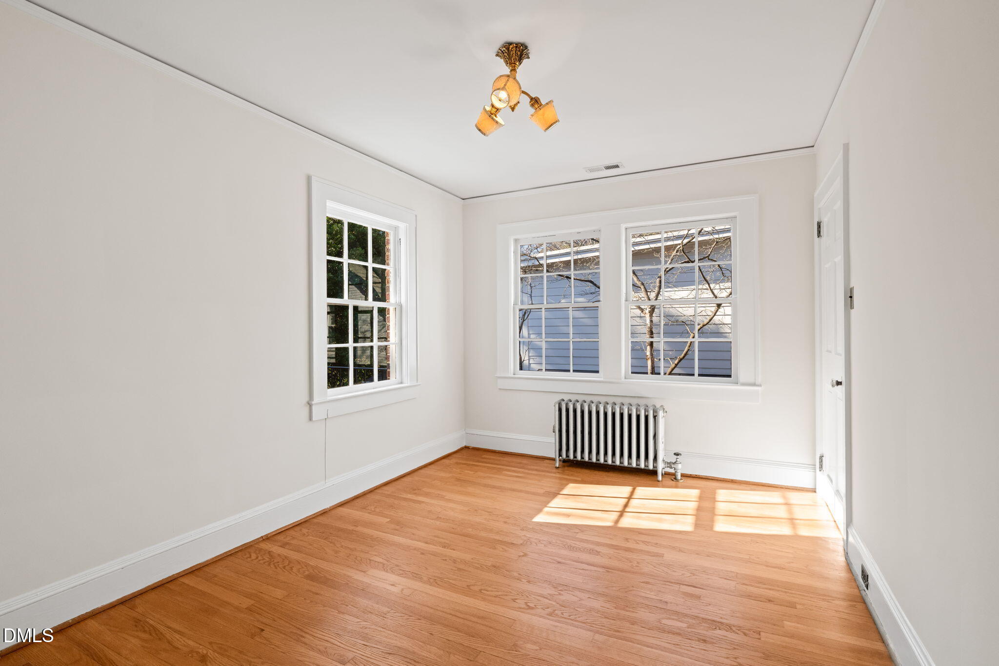 907 West Johnson Street Raleigh, NC 27605 - Photo 23 of 43 an empty room with wooden floor and windows
