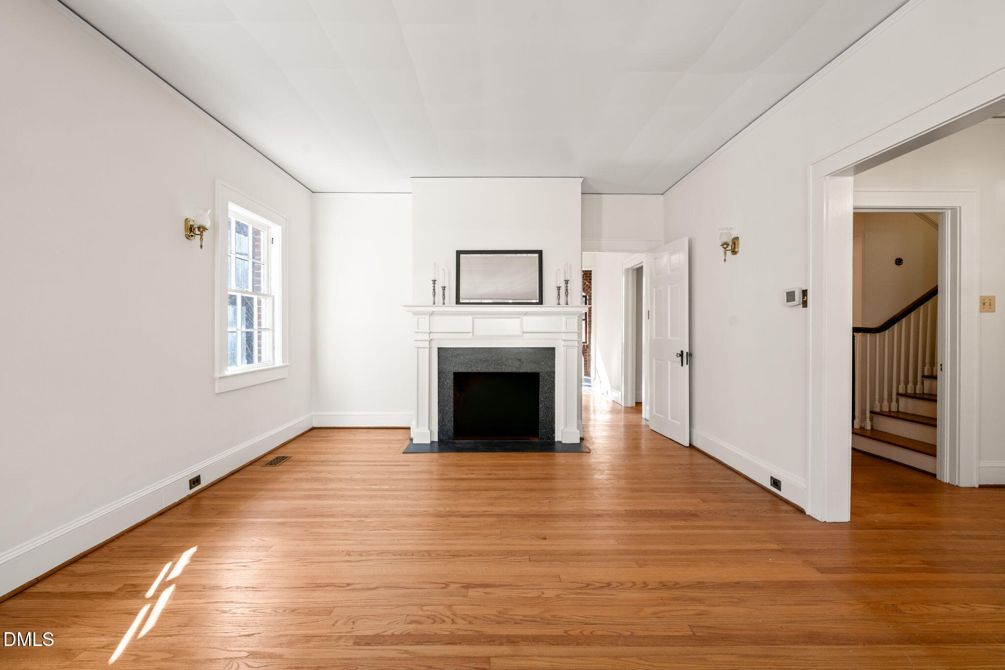 907 West Johnson Street Raleigh, NC 27605 - Photo 41 of 43 a view of a livingroom with a fireplace a ceiling fan and windows