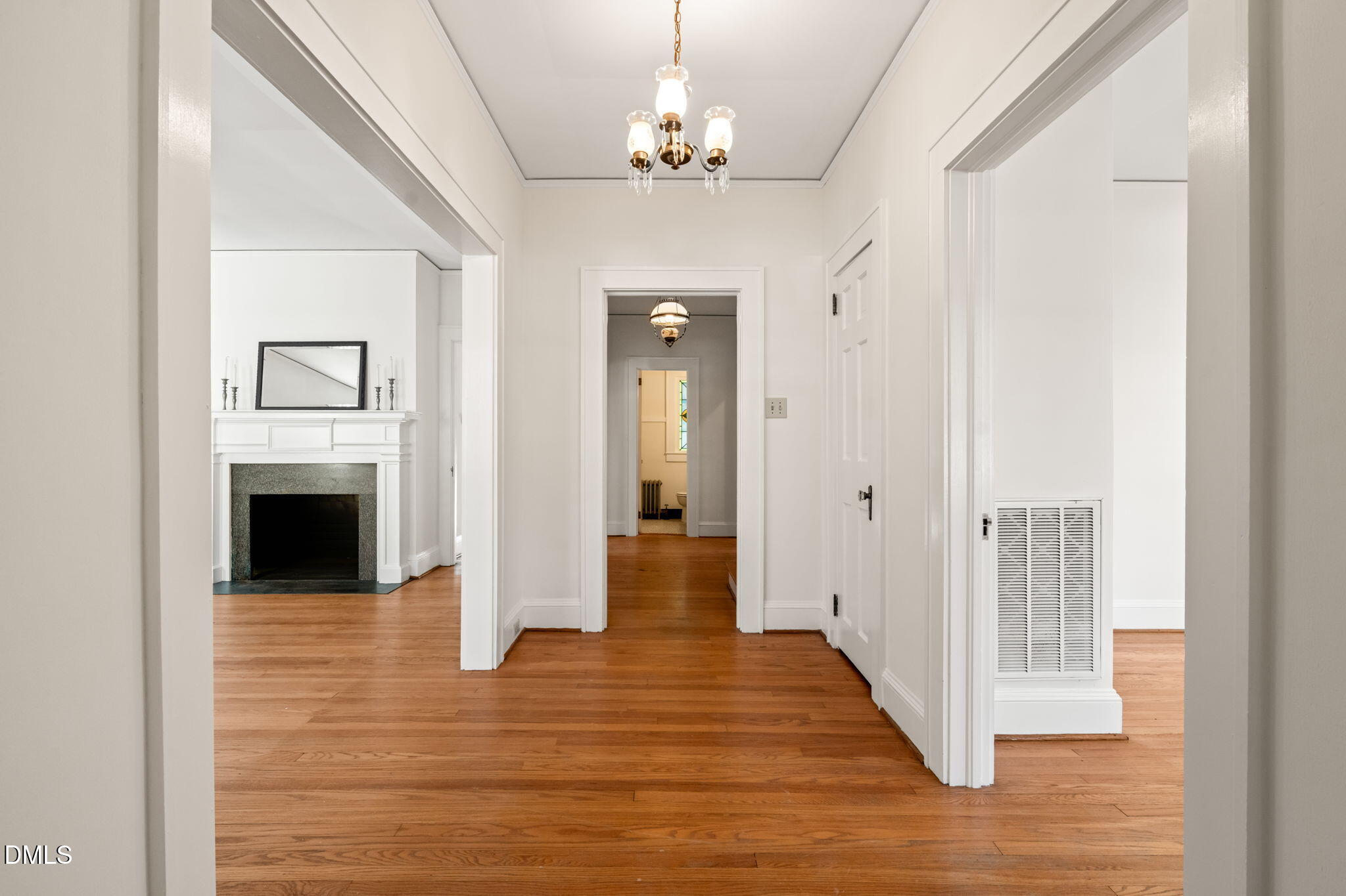 907 West Johnson Street Raleigh, NC 27605 - Photo 6 of 43 a view of a hallway with wooden floor and a fireplace