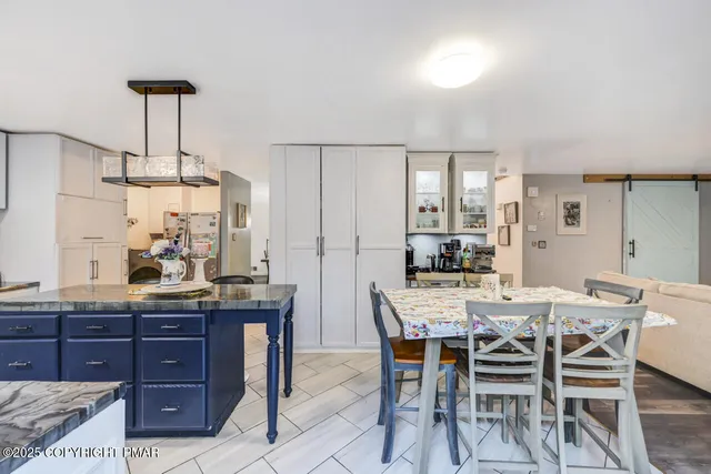 a living room with furniture a window and a dining table