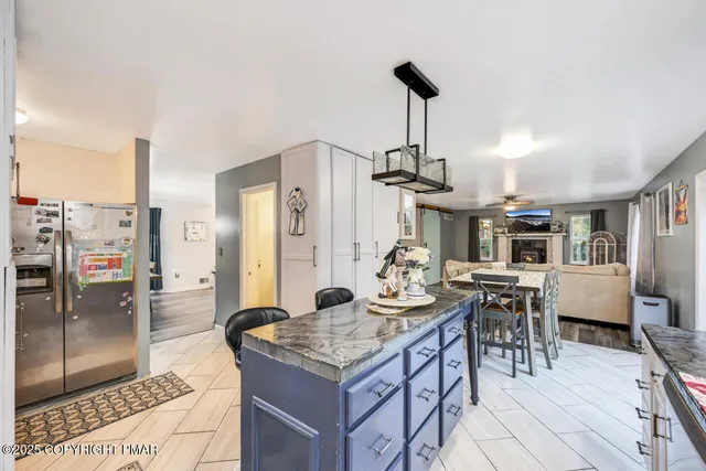a living room with furniture fireplace and a large window