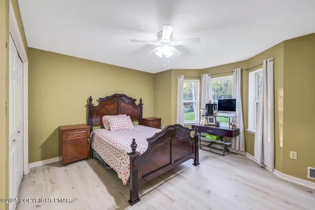a view of a room with wooden floor and windows