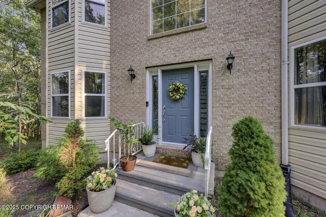 front view of a house with potted plants