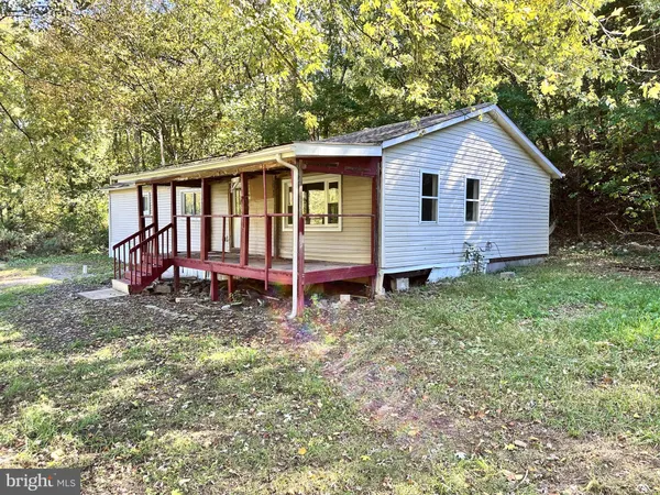 a view of a house with a yard and fence