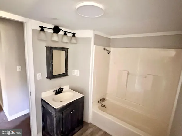 a bathroom with a sink a mirror and a bathtub