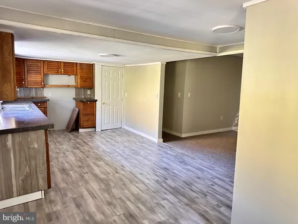 a view of a room with furniture and wooden floor