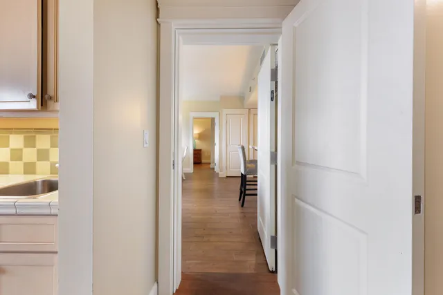 a bedroom with a bed and a large mirror on a dresser