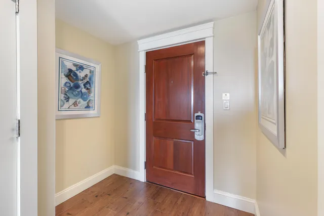 a kitchen with white cabinets and sink