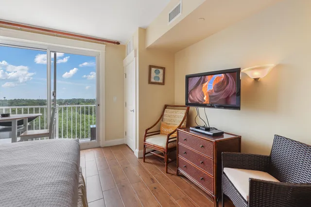 a bedroom with furniture and a flat screen tv