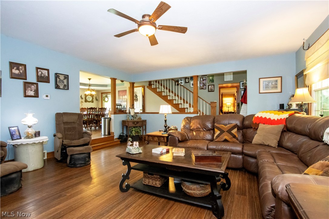 1043 North Honeytown Road Wooster, OH 44691 - Photo 5 of 46 Living room featuring wood-finish flooring, a ceiling fan with integrated lighting, and light blue wall tones