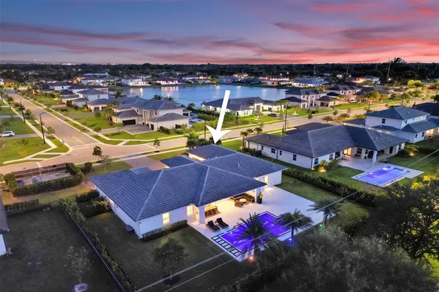 an aerial view of a houses with a swimming pool